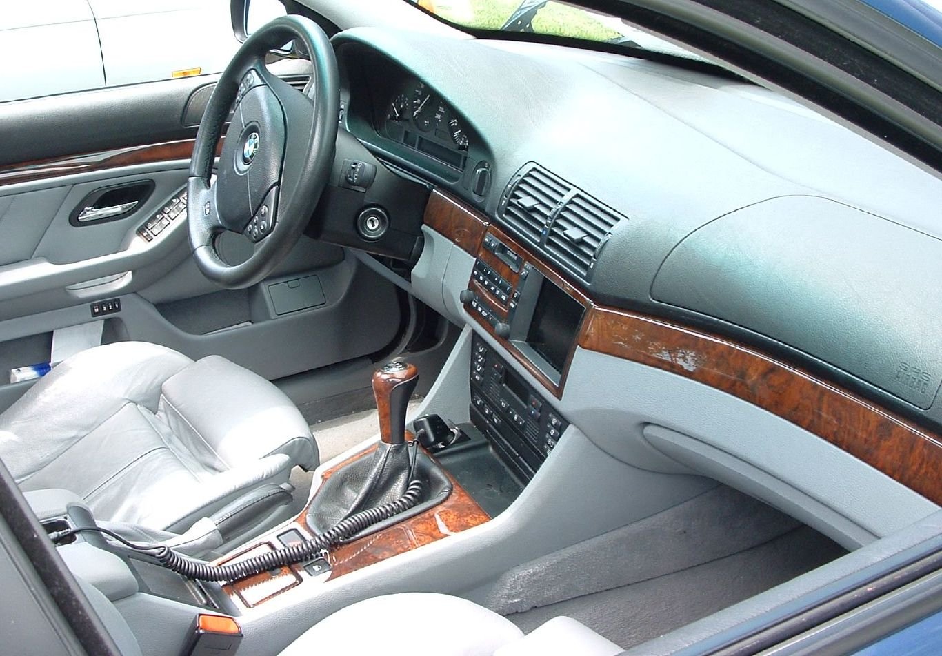 BMW E39 5 Series interior with grey leather and walnut trim, manual gearbox
